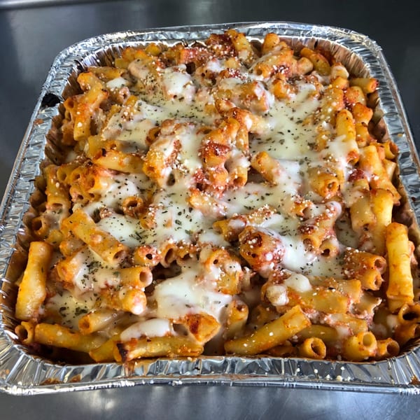 Baked ziti pasta with melted mozzarella cheese and herbs in a foil pan from Original Brothers Pizza.